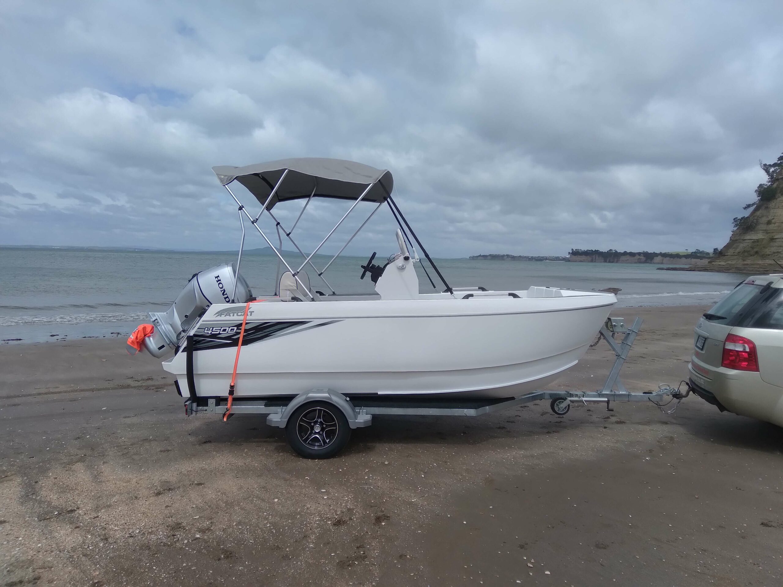 White FatCat 4500 with canopy on beach about to be launched